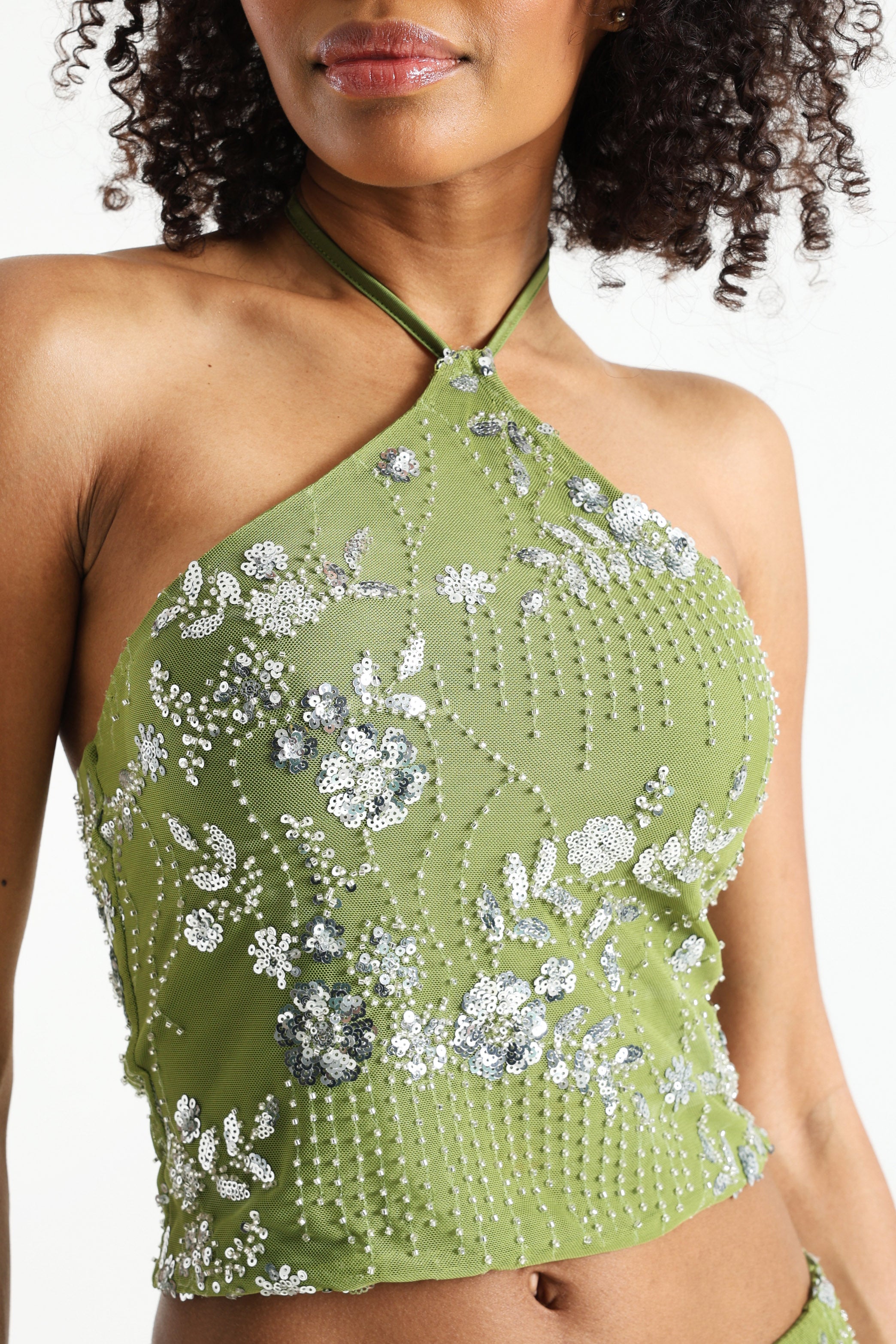 Top corto con schiena scoperta in mesh con paillettes